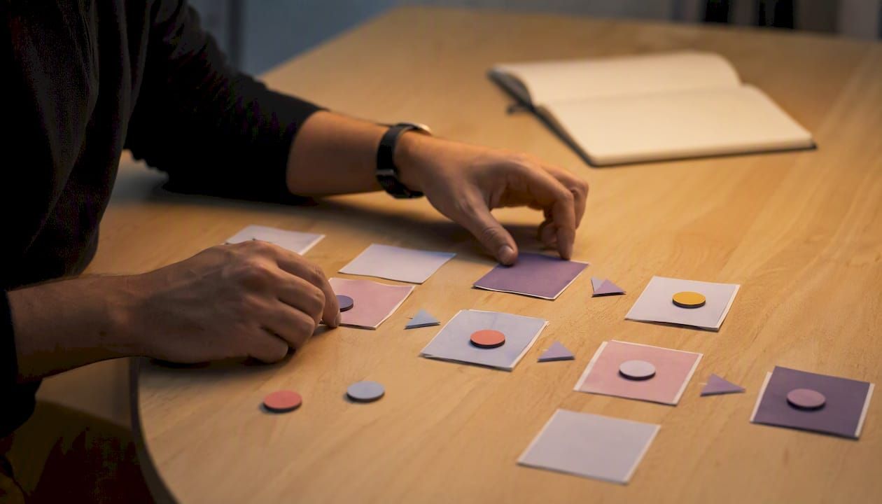 1786240261450_Hands-arranging-prototype-UX-flow-cards.jpeg