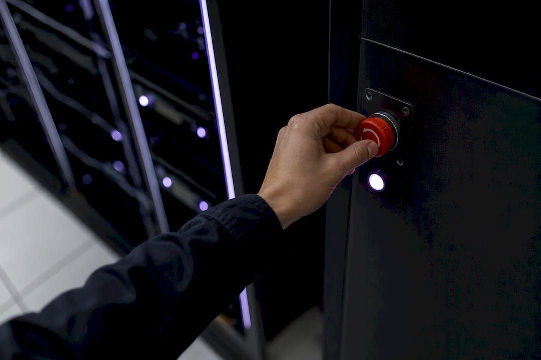 Hand toggling emergency kill switch on AI control panel