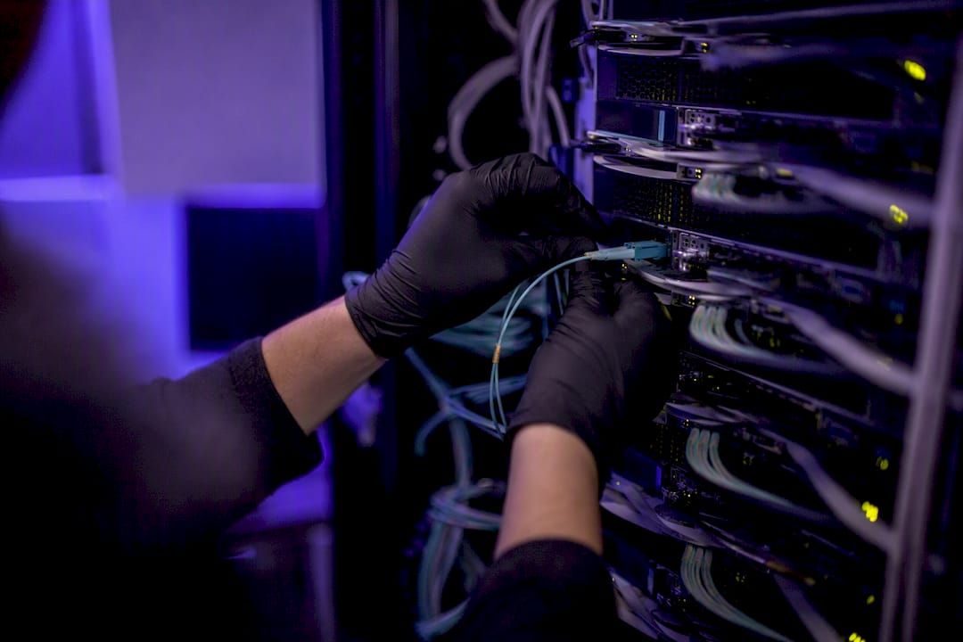 Hand connecting cable to server rack port
