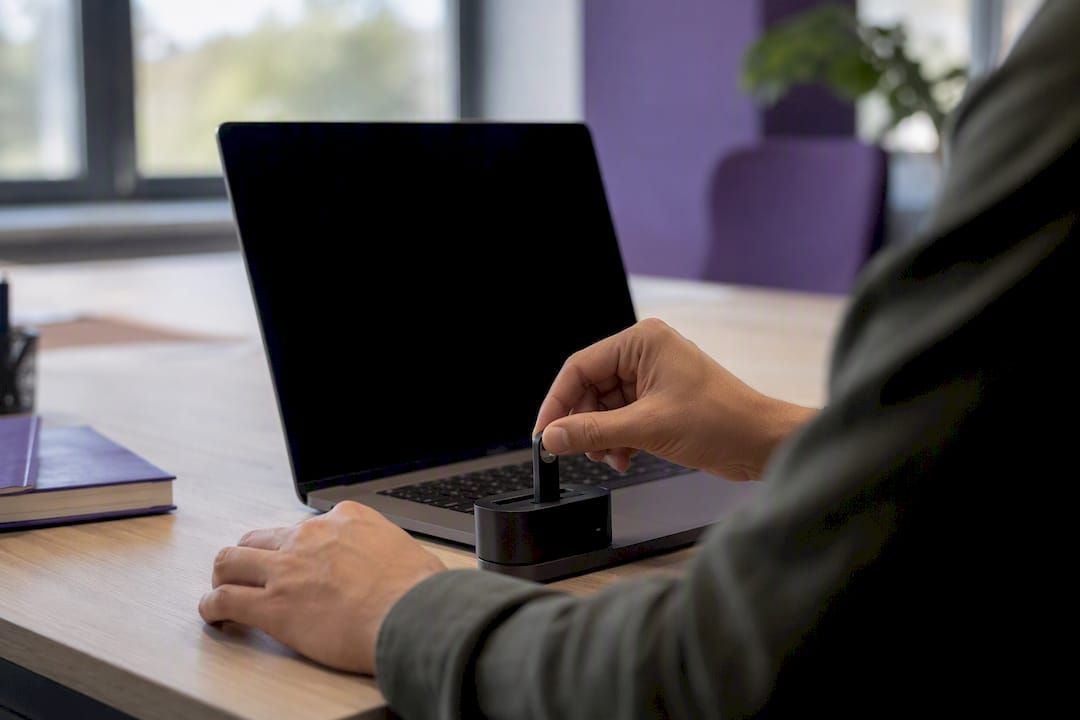 Hands inserting hardware MFA key