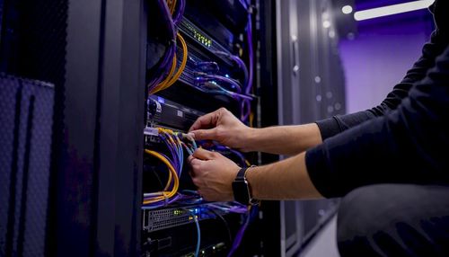 1786478696191_Hands-connecting-network-cables-in-server-rack.jpeg