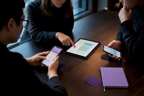 Engineers reviewing localized mobile app experiences